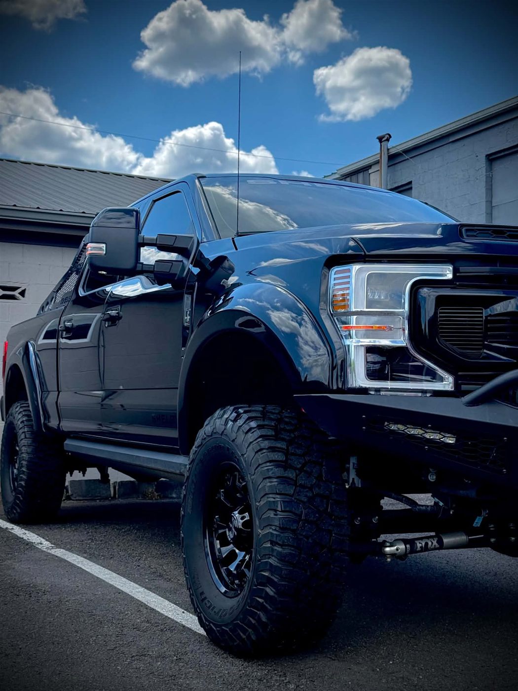Lifted black Ford Super Duty protected front end