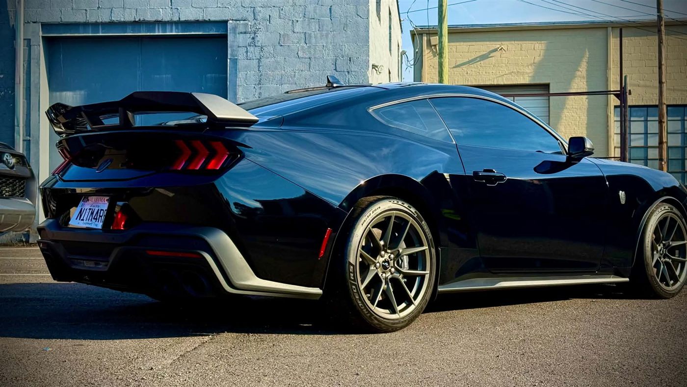 Black Mustang Dark Horse rear three-quarter view after full detail